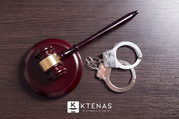 a gavel and handcuffs on a table