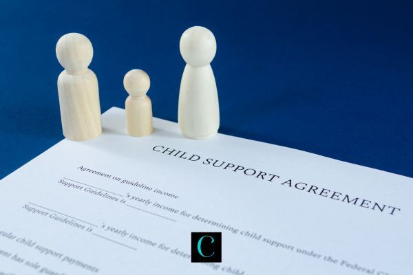 model figures of a family and a child support order on a table