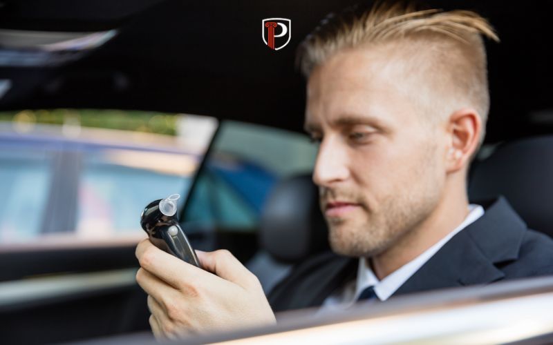 a man in a car reading baiid results