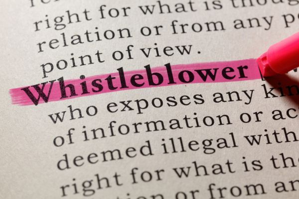 the definition of whistleblower being highlighted in a dictionary