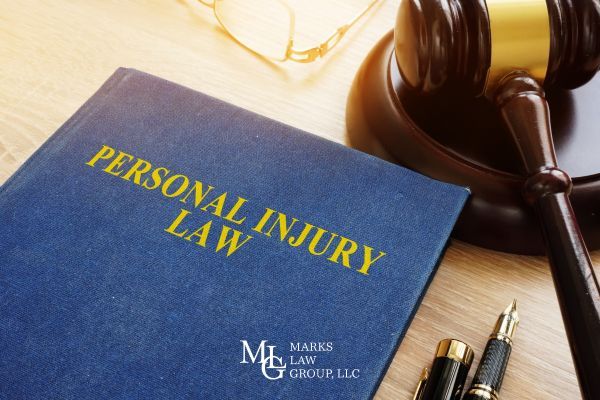 a book covering injury law and a gavel on a desk