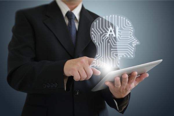 man pointing to table with ai head coming off screen