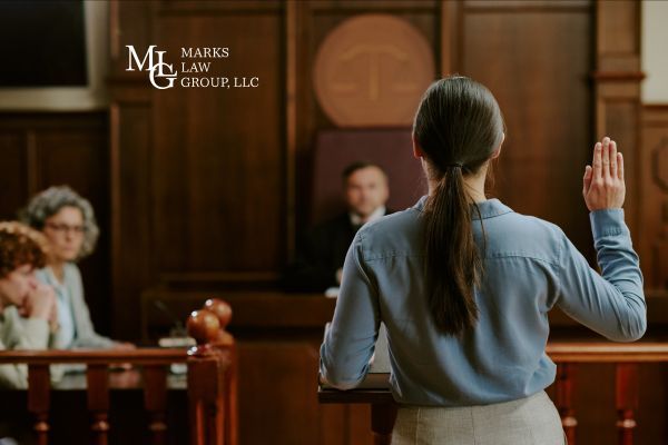 woman in court room raising right hand to swear and give testimony