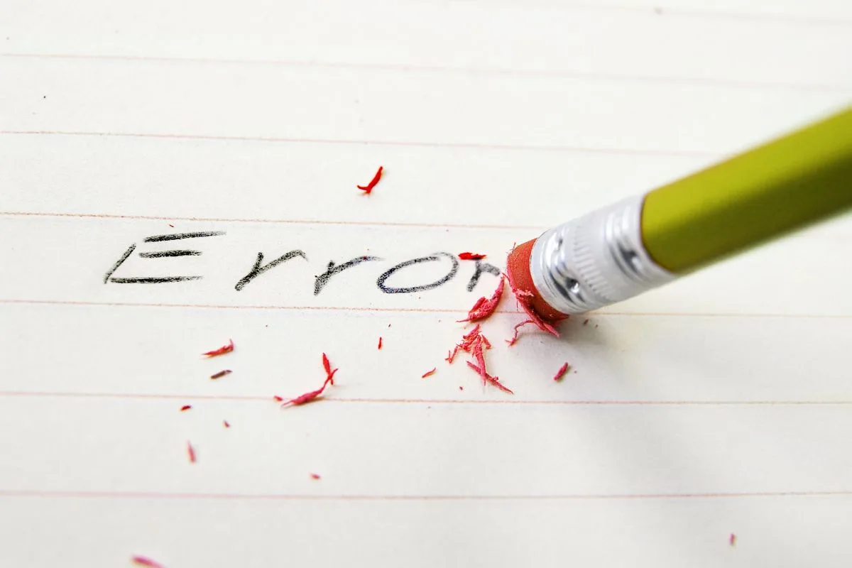 Pencil eraser deleting the word "error" on a paper. Conveys the importance of correcting credit report errors.