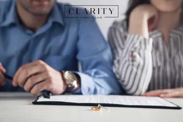 Couple in divorce lawyer's office with wedding band in front of them