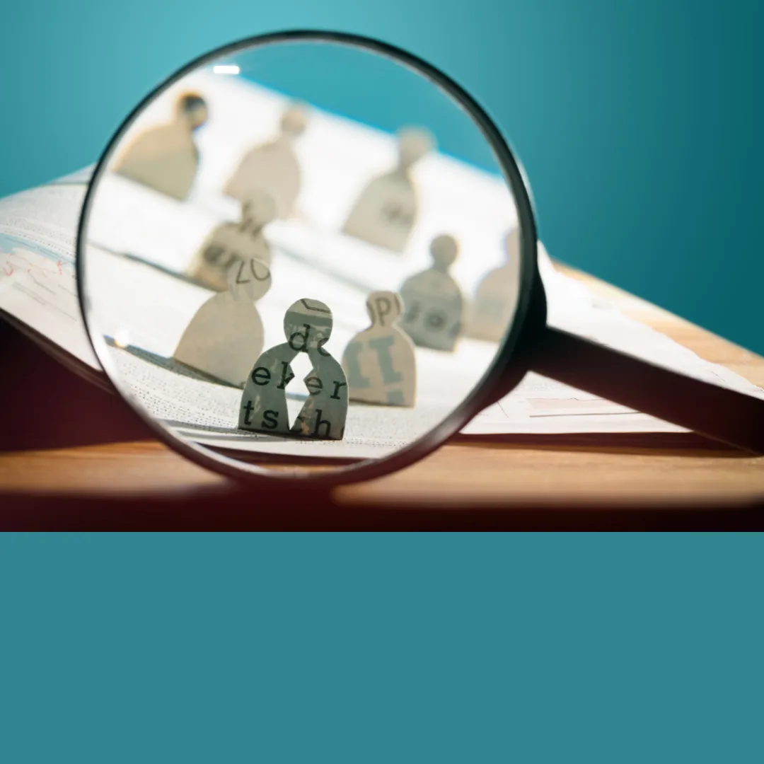 A magnifying lens brings small human shapes into focus, one with a split in it. It suggests the seriousness of HireRight background check errors.