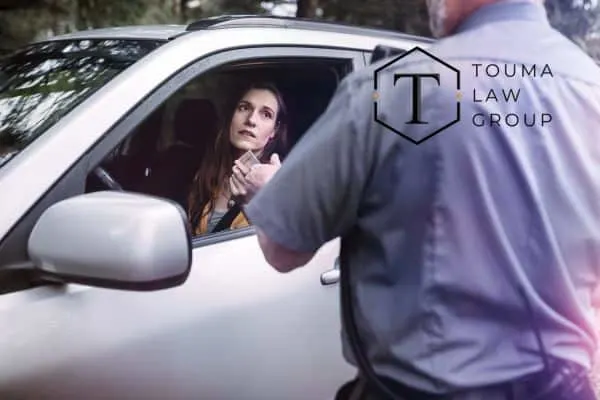 Woman in silver car pulled over by police
