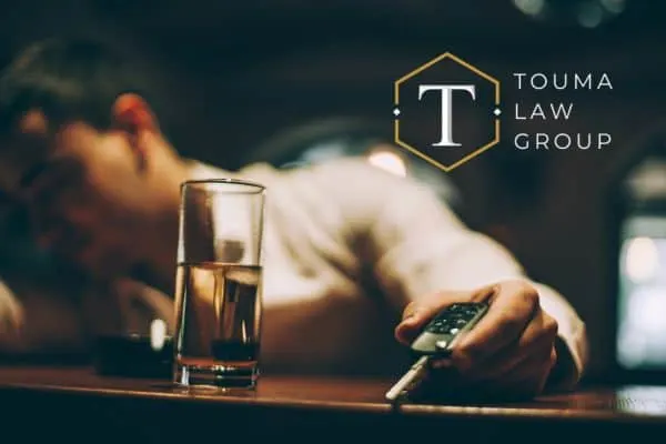 a man at the bar holding his car keys after having too much to drink