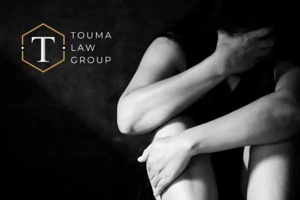 Shadowed image of domestic violence victim curled up