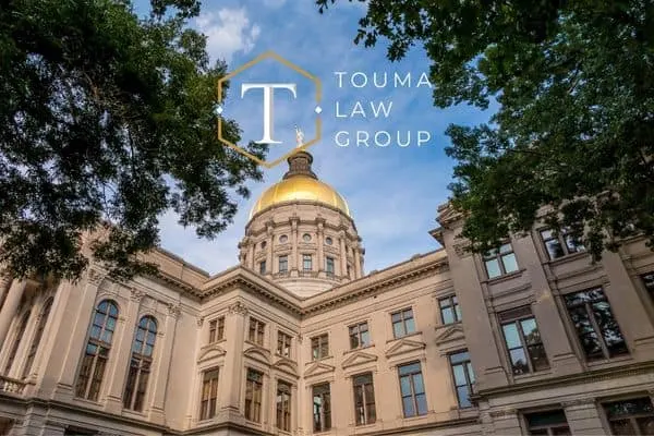 judicial building with gold dome surrounded by green trees