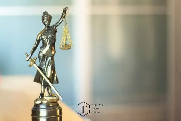 a statue of lady justice on a desk