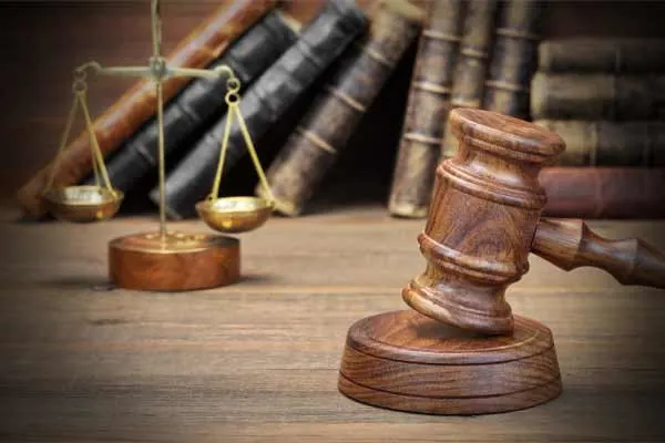 scales, books, and wood gavel on desk