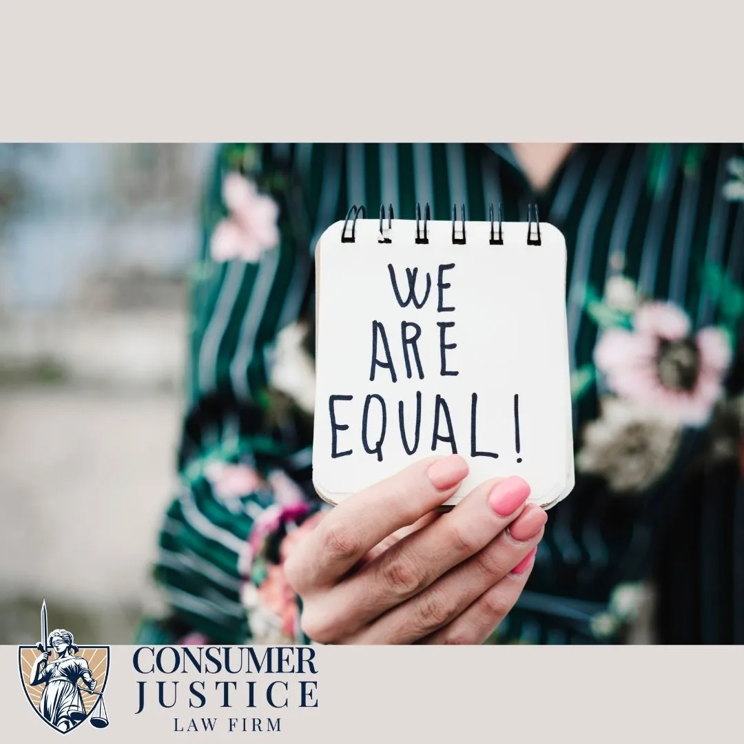 A sign reading "We are equal" conveys the seriousness of discrimination in the workplace.