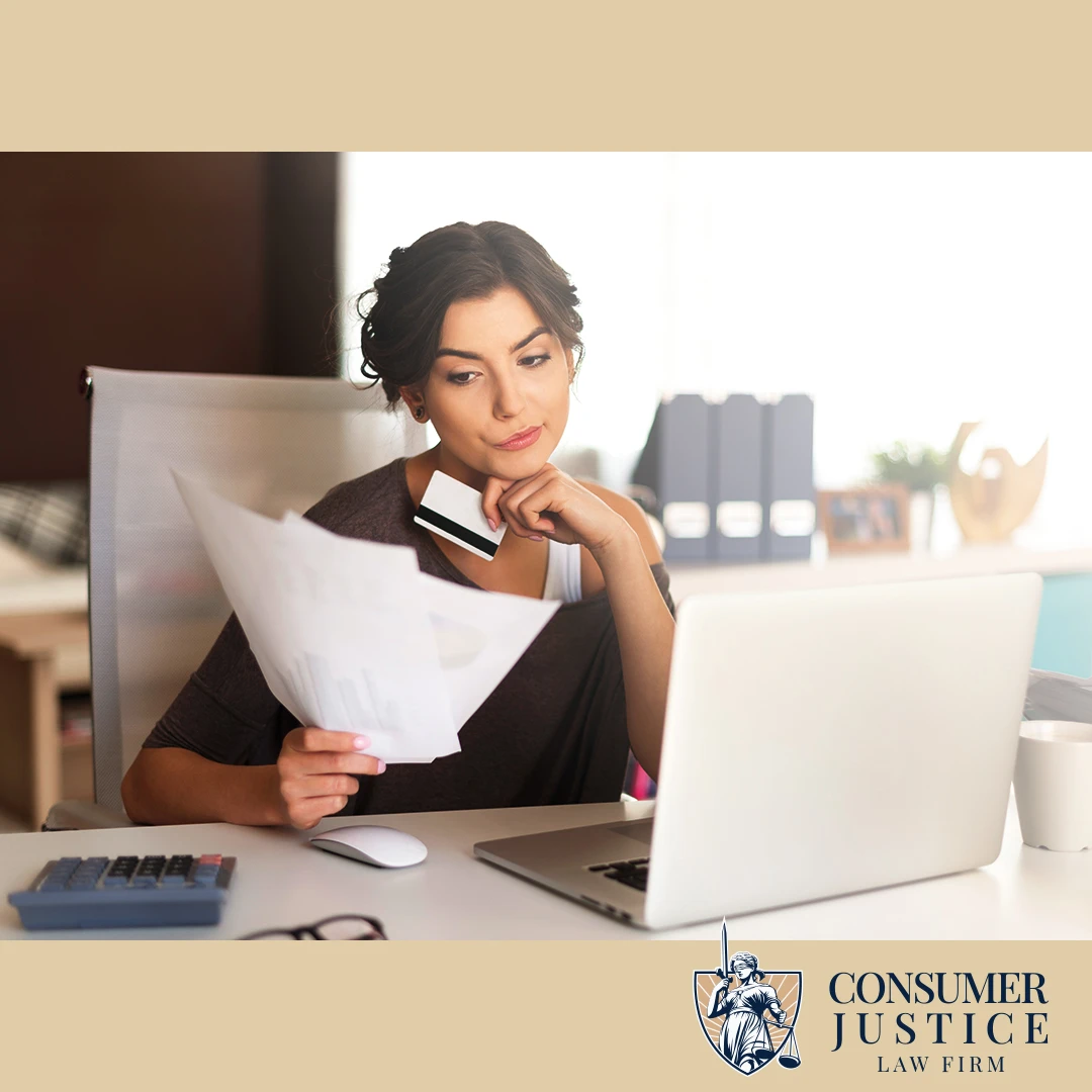 A concerned woman reviews paperwork, conveying a decision to work with a credit report lawyer.
