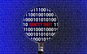 A magnifying glass over a background of binary code, highlighting the words "IDENTITY THEFT"