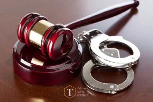 handcuffs and a gavel on a desk