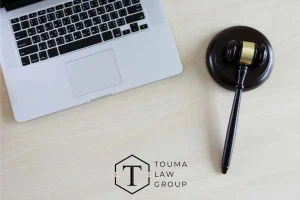 a laptop and gavel on a desk
