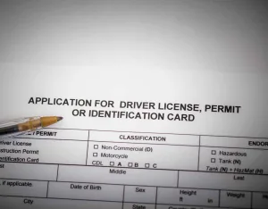 a drivers license application and pen