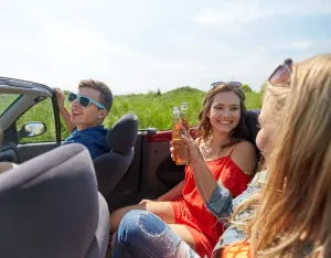 teenagers riding in a car with open alcohol