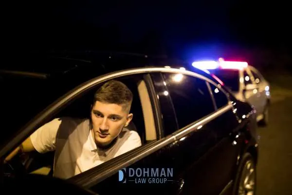a young man being puled over for driving under the influence