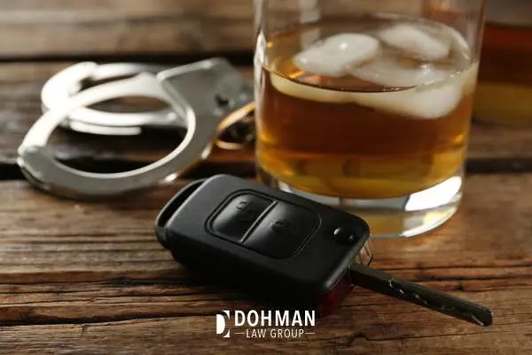 handcuffs, car keys, and alcohol on a table