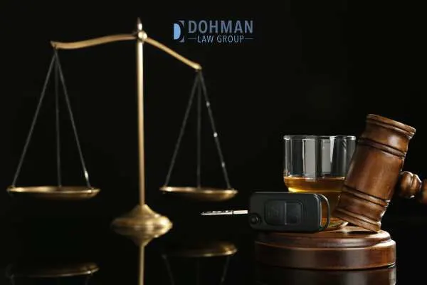 alcohol, car keys, and a gavel stand in front of a black background
