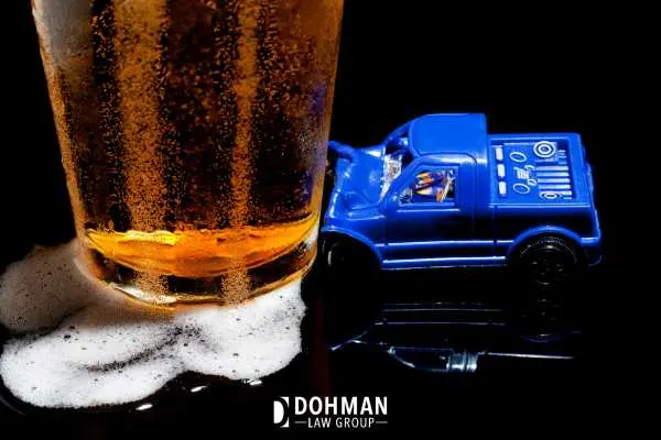 a models car and beer in front of a black background