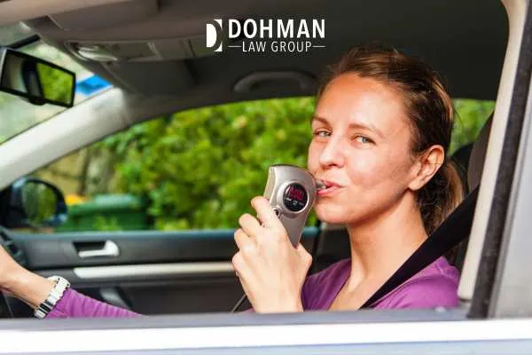 a woman starting a car with a baiid