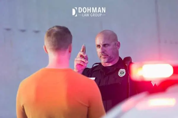a police officer administering a field sobriety test to a man
