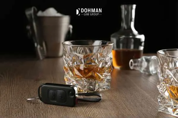 glass of alcohol with car key in front