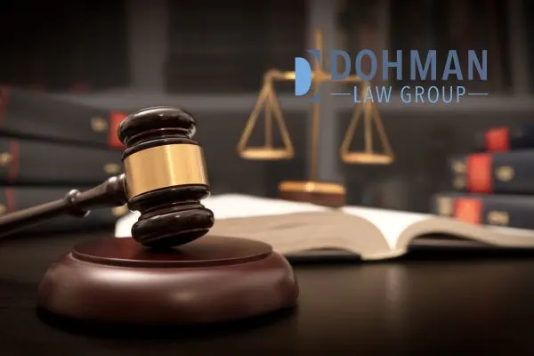 a gavel, scale, and law book on a desk