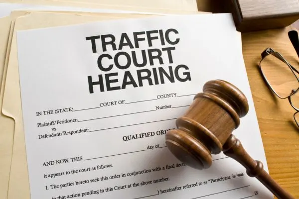 paperwork for a traffic court hearing with a gavel next to it