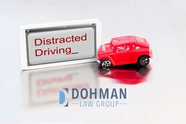 a toy car hitting a sign that reads "distracted driving"