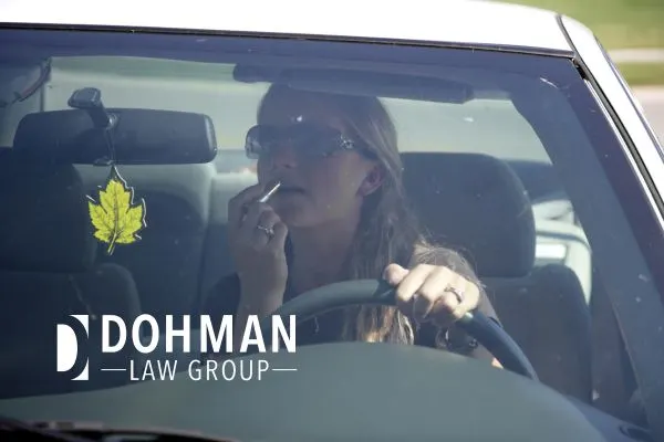 a woman putting on makeup while driving in Illinois