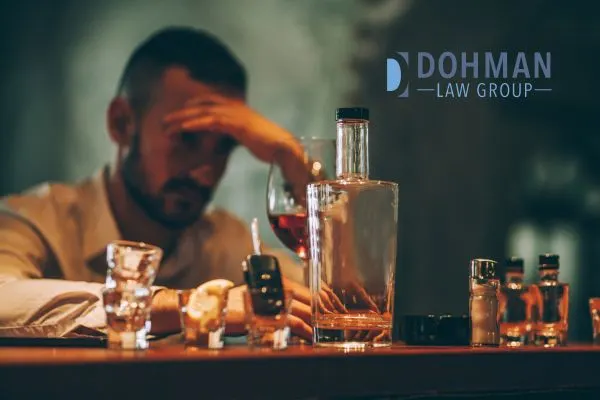 a man sitting at the bar with a bunch of empty glasses of alcohol
