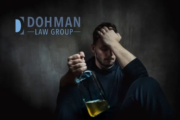 a man holding a glass of alcohol