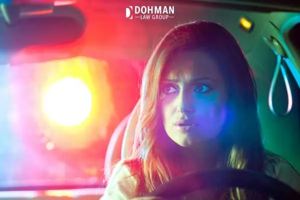 a woman being stopped by the police while driving