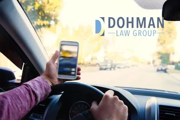 someone using their phone to take a picture while driving