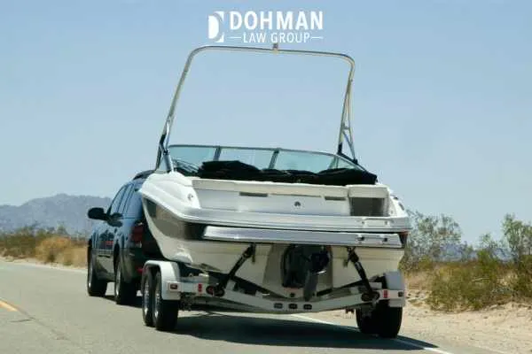 a vehicle towing a boat to a lake