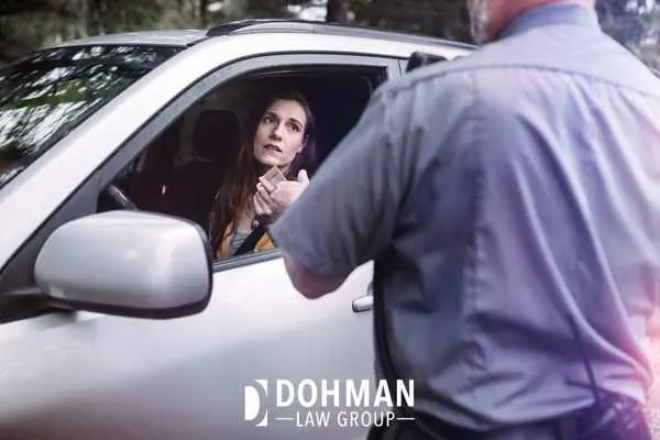 a police officer checking a womans id after pulling her over