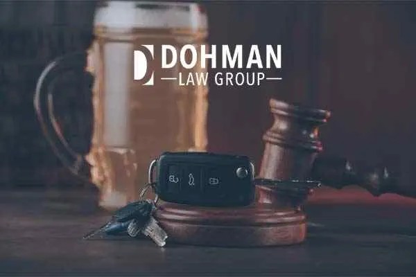 car keys, a beer, and a gavel on a desk