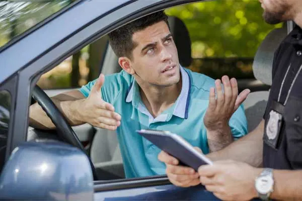 A man having a ticket issued to him for speeding.