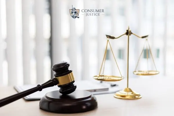 a gavel, scales, and legal documents on a desk