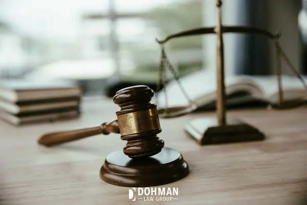 a gavel, scales, and law books on an attorneys desk