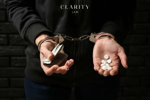 a woman in handcuffs holding drugs and money