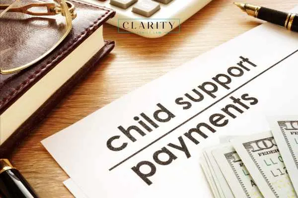Child support documents with money resting on top