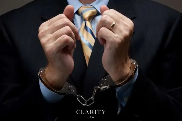 a handcuffed man in a suit