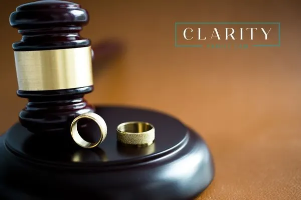 Two wedding bands resting on a gavel
