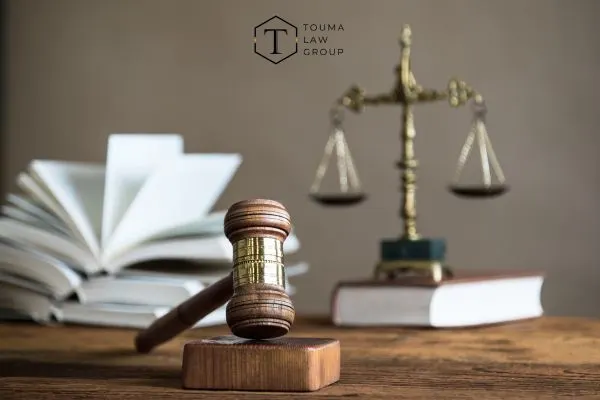 law books, scales, and a gavel on a desk in an office