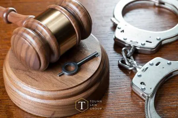 a desk with handcuffs and a gavel on it